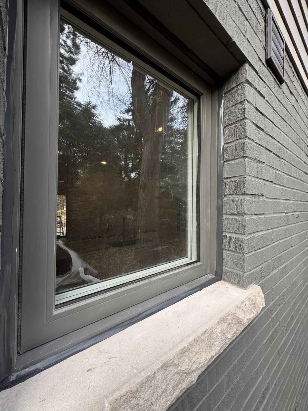 Sealed joint around an exterior window frame where it meets brick